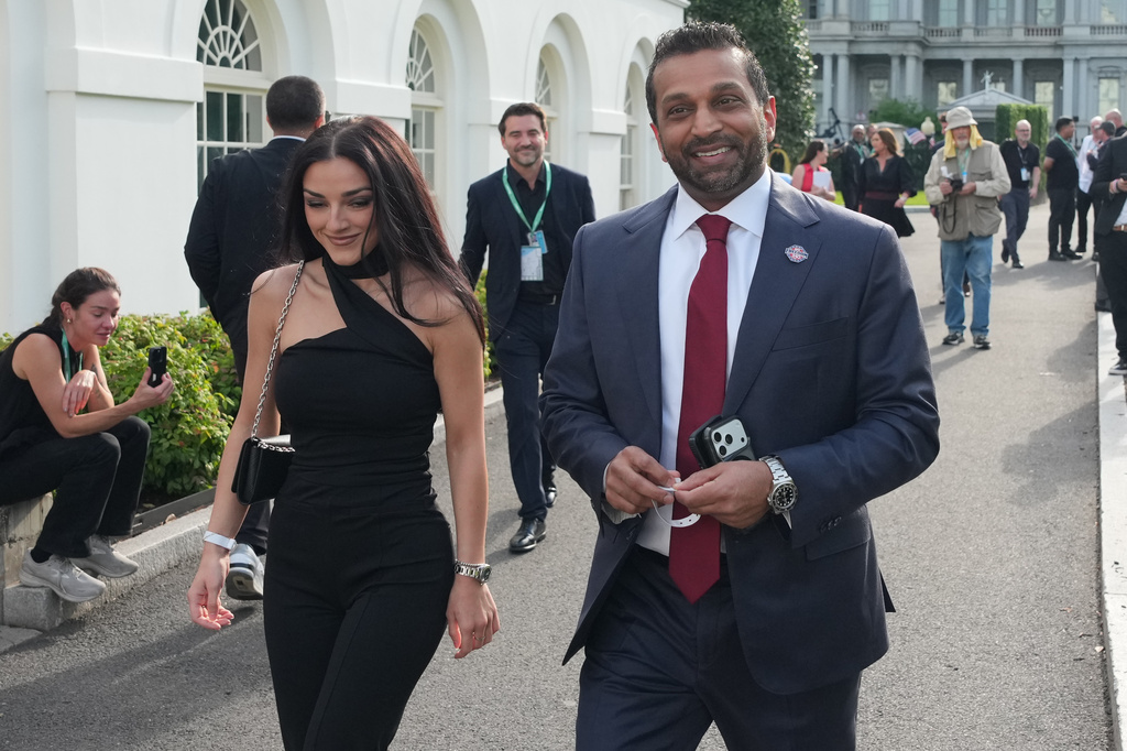 FILE - FBI director Kash Patel, right, and Alexis Wilkins arrive at the White House ahead of the UFC Freedom 250 on the South Lawn, June 14, 2026, in Washington. (AP Photo/Alex Brandon, File)