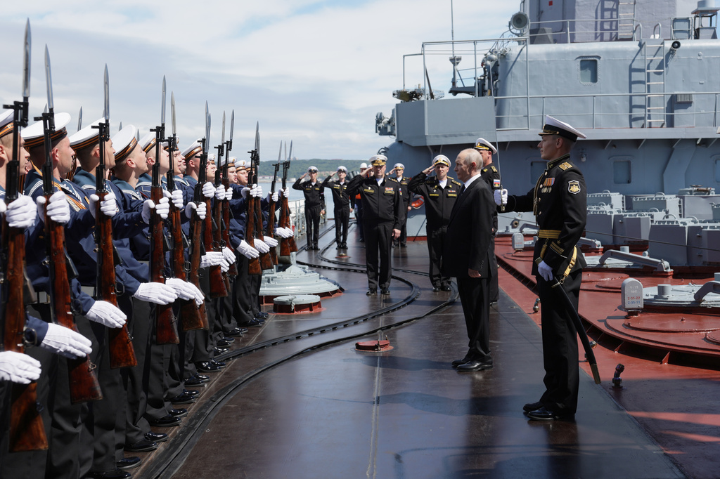 Russian President Vladimir Putin, second right, visits the Varyag missile cruiser of the Pacific Fleet to watch a military exercise near Yuzhno-Sakhalinsk, on Sakhalin Island, Russia, Wednesday, Aug. 12, 2026. (Gavriil Grigorov, Sputnik, Kremlin Pool Photo via AP)