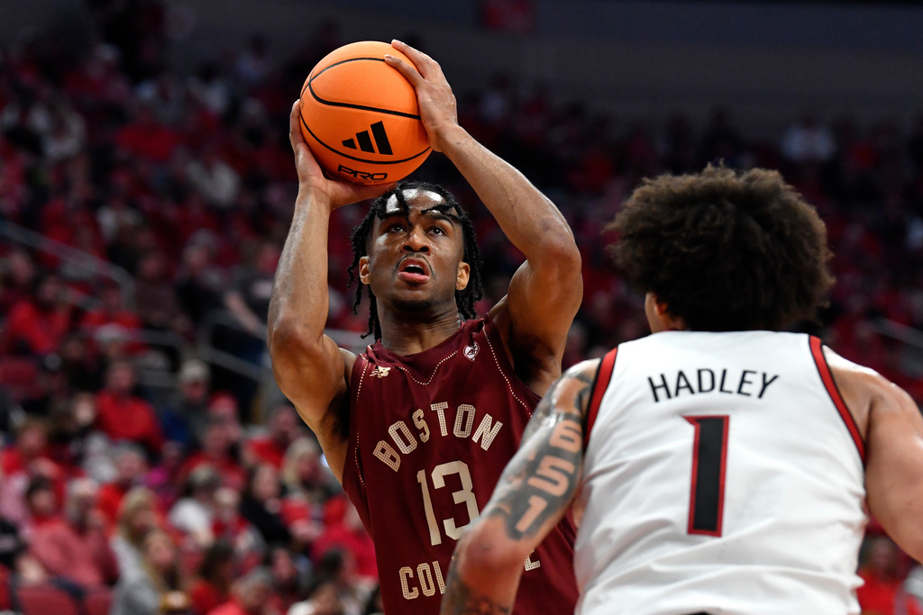 Boston College guard Donald Hand Jr. (13) shoots over Louisville guard J'vonne Hadley (1) during the first half of an NCAA college basketball game in Louisville, Ky., Saturday, Jan. 10, 2026. (AP Photo/Timothy D. Easley)