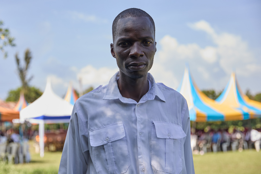 Lawrence Ouma Angira stands during his uncle's funeral and says he finds comfort in having professional mourners present on the outskirts of Kisumu, Kenya, Friday, March 13, 2026. (AP Photo/Asa Wallin)