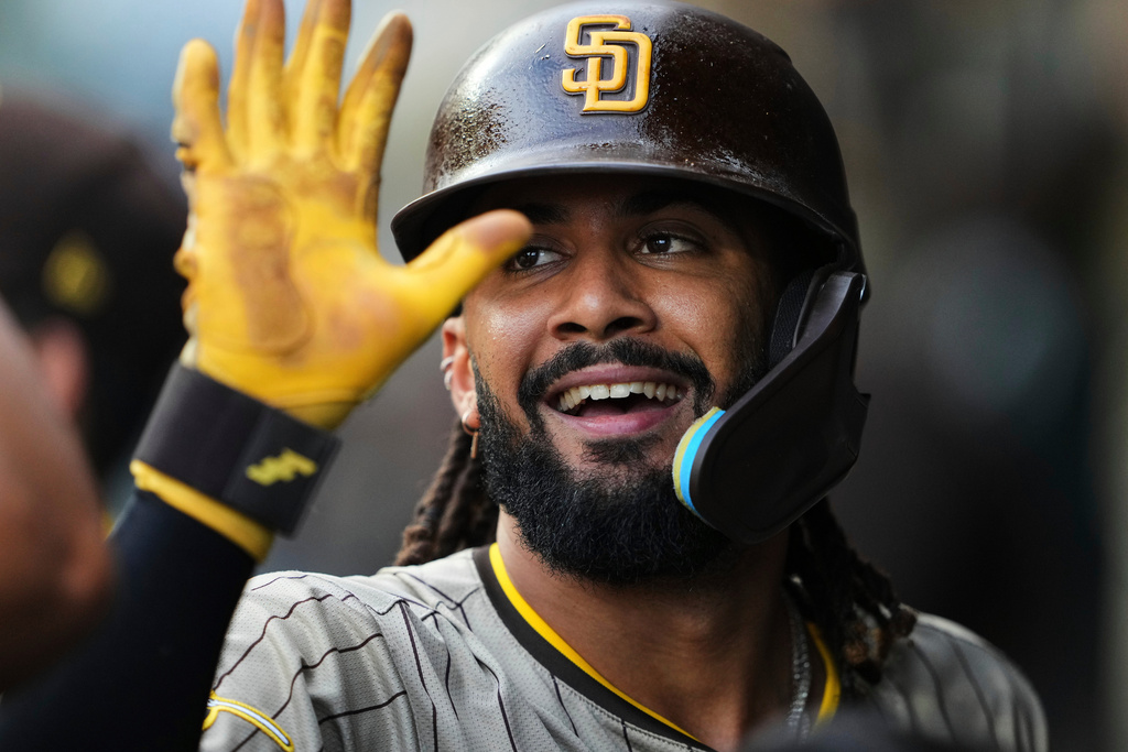 FILE - San Diego Padres' Fernando Tatis Jr. smiles after scoring on an RBI single from Xander Bogaerts against the Seattle Mariners during the first inning of a baseball game Tuesday, Aug. 26, 2025, in Seattle. (AP Photo/Lindsey Wasson, File)