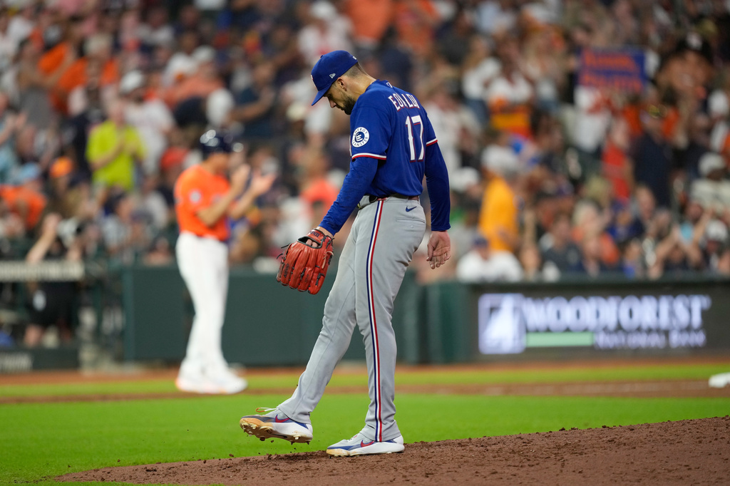 Texas Rangers starting pitcher Nathan Eovaldi reacts after giving up a home run to Houston Astros' Isaac Paredes during the fifth inning of a baseball game Friday, July 31, 2026, in Houston. (AP Photo/David J. Phillip)