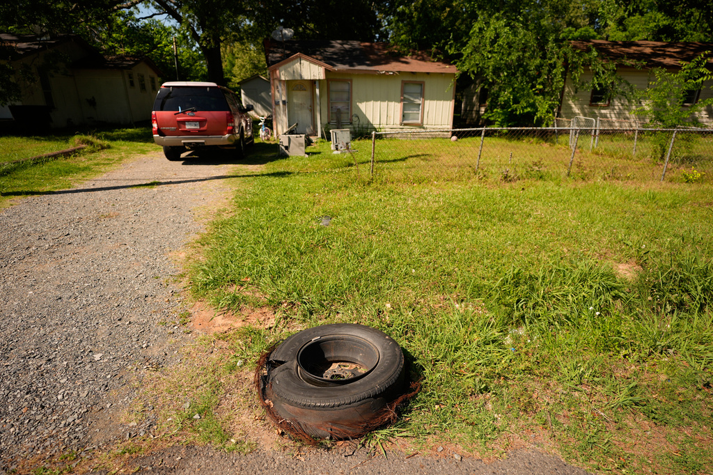 A vehicle is parked outside one of the locations of a mass shooting, Sunday, April 19, 2026, in Shreveport, La. (AP Photo/Gerald Herbert)