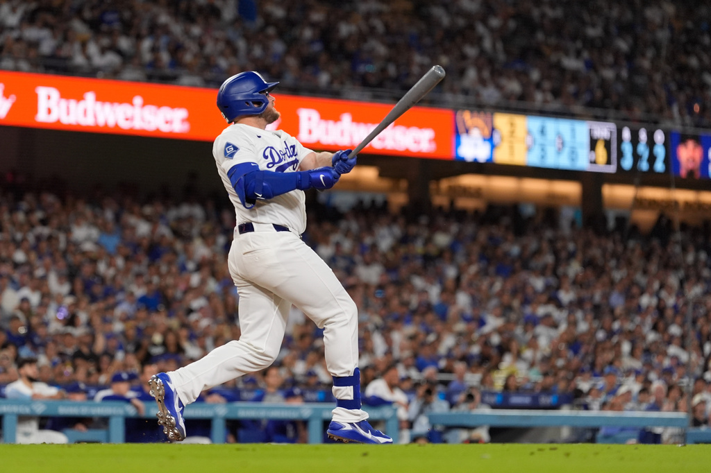 Los Angeles Dodgers' Max Muncy hits a three-run home run during the sixth inning of a baseball game against the Milwaukee Brewers, Thursday, Aug. 13, 2026, in Los Angeles. (AP Photo/Mark J. Terrill)