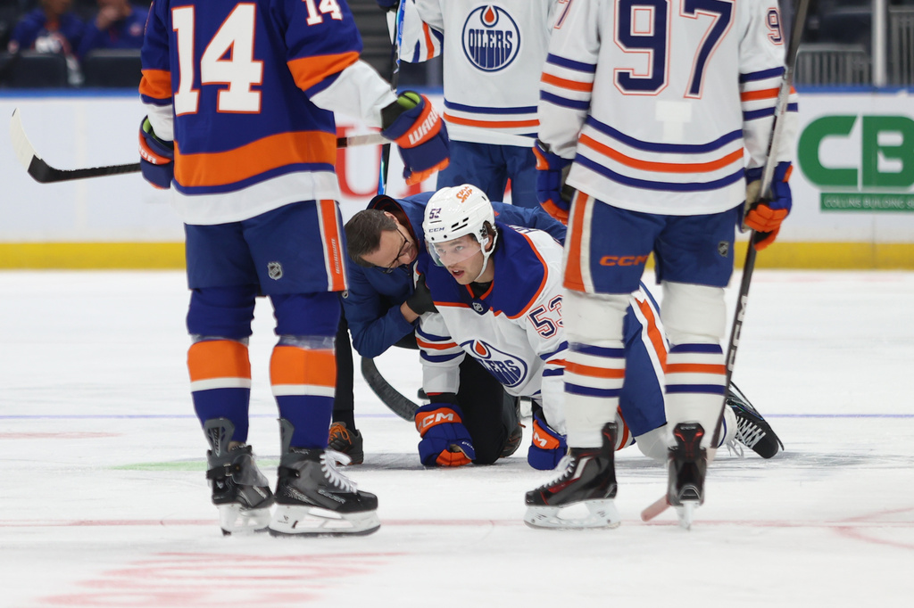 Edmonton Oilers' Isaac Howard (53) is attended to after an apparent injury during the first period of an NHL hockey game against the New York Islanders, Saturday, Oct. 31, 2026, in Elmont, N.Y. (AP Photo/Pamela Smith)