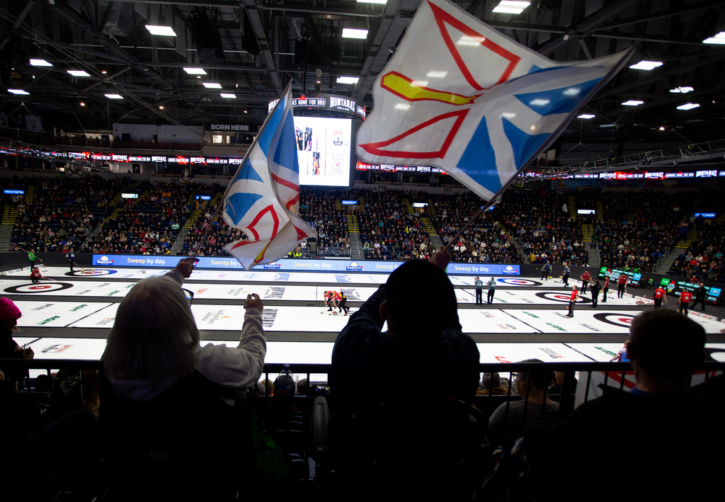 Fans wave Newfoundland and Labrador flags during Draw 5 at the Brier curling event in St. John's, Newfoundland and Labrador, Sunday, March 1, 2026. (Paul Daly/The Canadian Press via AP)