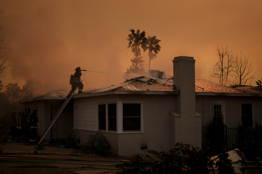 Fire crews battle the Eaton Fire as it impacts a structure Thursday, Jan. 9, 2025 in Altadena, Calif. (AP Photo/Eric Thayer)