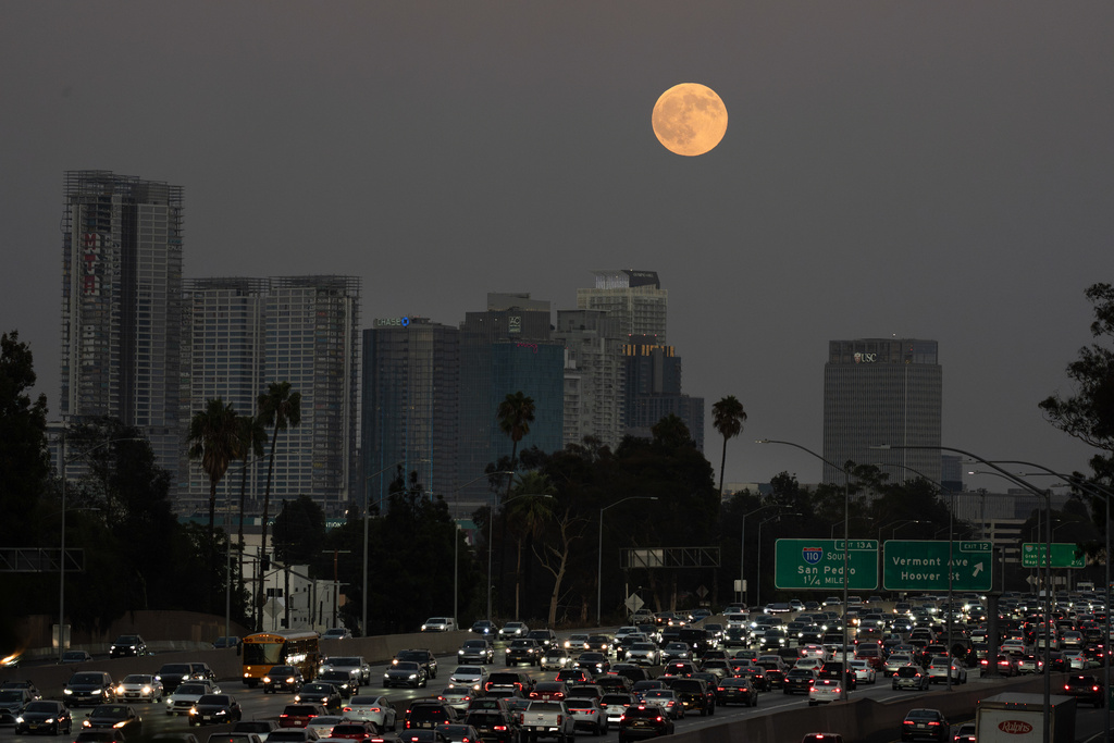 The Harvest Moon rises over Los Angeles, Monday, Oct. 6, 2025. (AP Photo/Jae C. Hong)