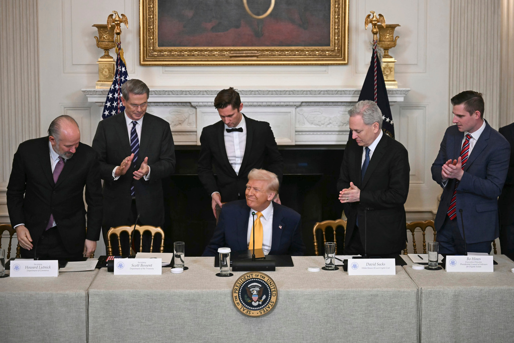 FILE - President Donald Trump, center, sits as Secretary of Commerce Howard Lutnick, from left, Treasury Secretary Scott Bessent, and from right, Bo Hines, a member of the presidential council of advisers for digital assets, and White House AI and crypto czar David Sacks attend the White House Crypto Summit in Washington, March 7, 2025. (Pool via AP, File)