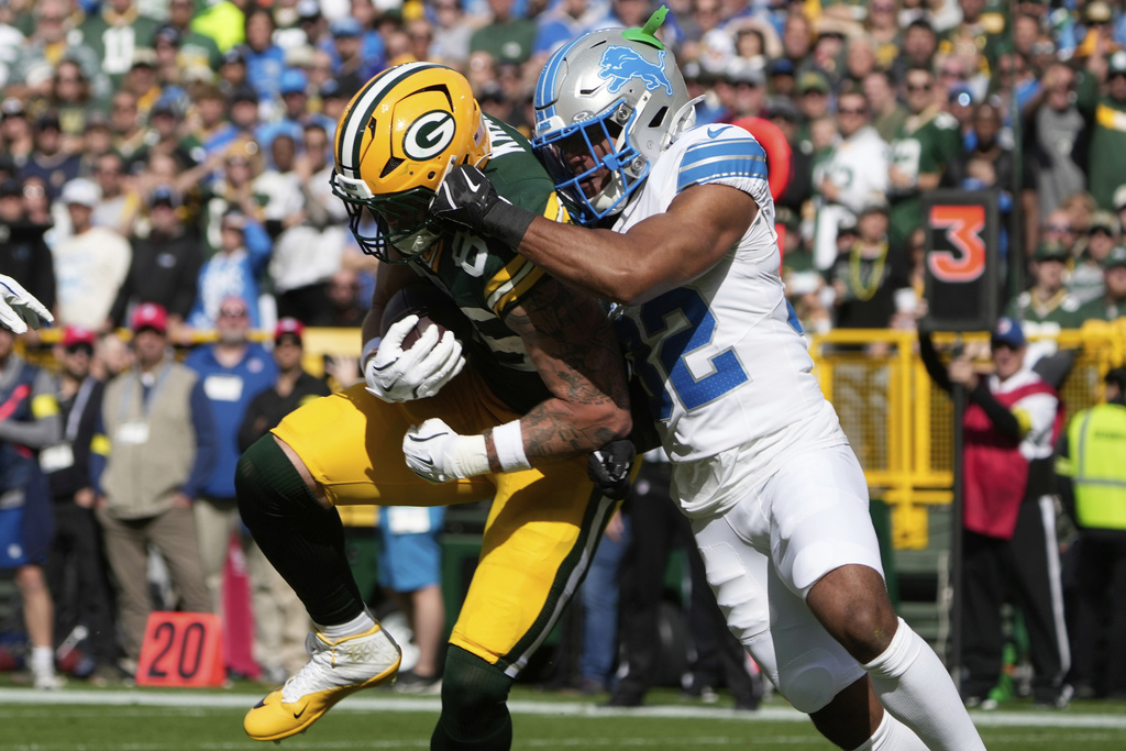 Green Bay Packers tight end Tucker Kraft (85) catches a 15-yard touchdown pass as Detroit Lions safety Brian Branch (32) defends during the first half of an NFL football game Sunday, Sept. 7, 2025, in Green Bay, Wis. (AP Photo/Morry Gash)