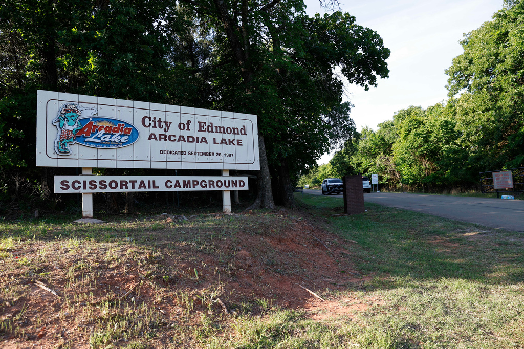 Officials block the entrance to Scissortail Campground at Arcadia Lake, Monday, May 4, 2026, in Edmond, Okla., after a shooting on Sunday evening. (AP Photo/Alonzo Adams)