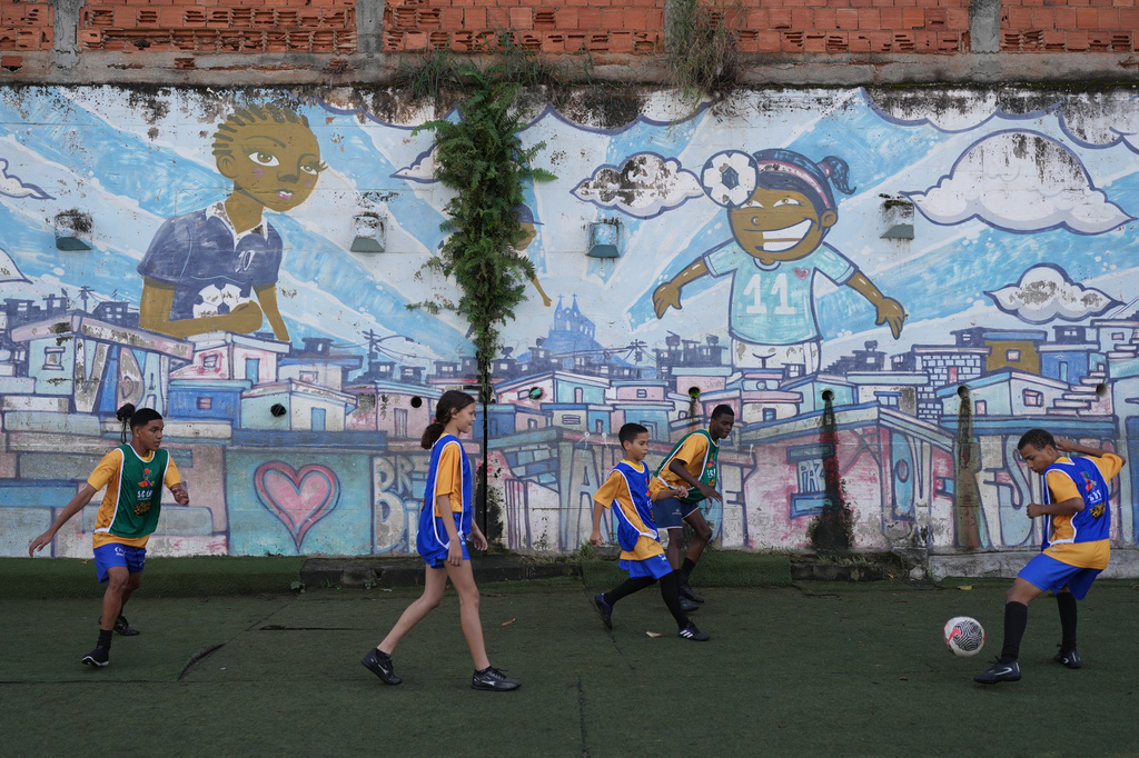 Teenagers attend a soccer training session by the Street Child United Brazil social project in the Complexo da Penha of Rio de Janeiro, Wednesday, June 3, 2026. (AP Photo/Silvia Izquierdo)