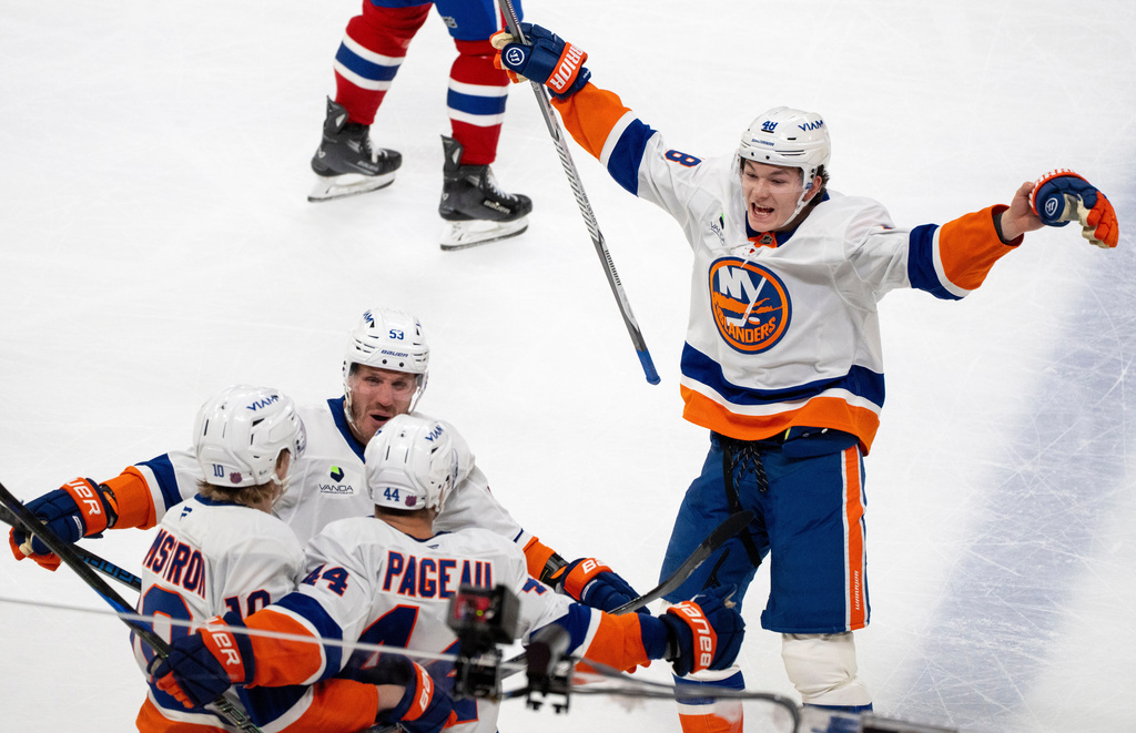 New York Islanders' Jean-Gabriel Pageau (44) celebrates after his winning goal with teammates Simon Holmstrom (10), Casey Cizikas (53) and Matthew Schaefer (48) during overtime NHL hockey game action against the Montreal Canadiens in Montreal, Thursday, Feb. 26, 2026. (Christinne Muschi/The Canadian Press via AP)