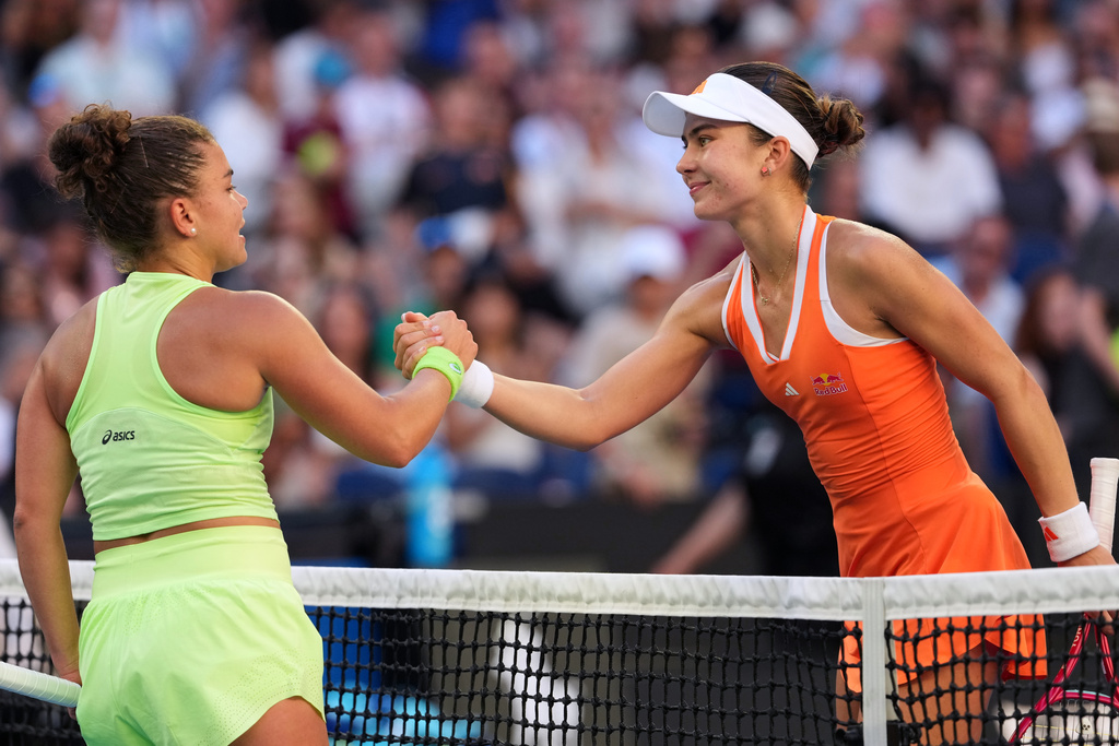 Iva Jovic, right, of the U.S. is congratulated by Jasmine Paolini of Italy following their third round match at the Australian Open tennis championship in Melbourne, Australia, Friday, Jan. 23, 2026. (AP Photo/Aaron Favila)