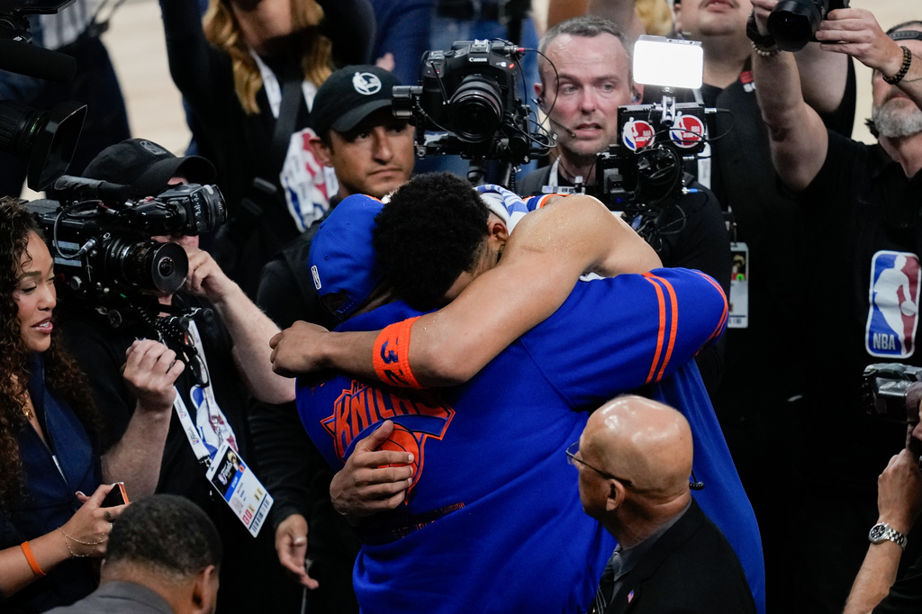 New York Knicks center Karl-Anthony Towns hugs his dad, Karl-Anthony Towns Sr., after Game 2 of the NBA Finals basketball series against the San Antonio Spurs, Friday, June 5, 2026, in San Antonio. (AP Photo/David J. Phillip)