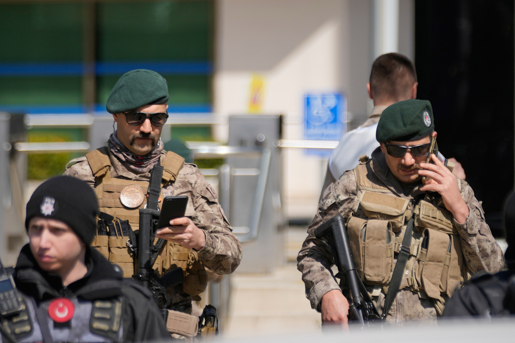 Turkish police and army secure the area after a gunmen attack at a building housing the Israeli Consulate in Istanbul, Turkey, Tuesday, April 7, 2026. (AP Photo/Khalil Hamra)