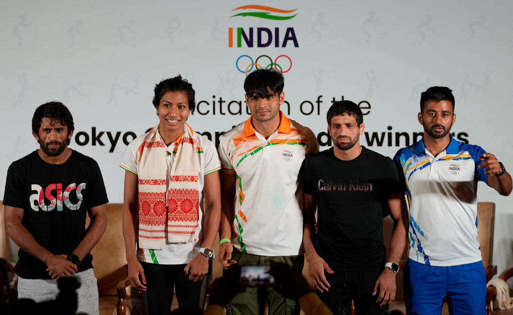 FILE - From left, Olympic Bronze medallist in wrestling Bajarng Punia, Olympic Bronze medallists in boxing, Lovlina Borgohain, Olympic Gold medallist in javelin throw Neeraj Chopra, Olympic Silver medallist in wrestling Ravi Dahiya and captain of Indian men's hockey team who won bronze medal, Manpreet Singh at Tokyo Olympic games, stand for a photographs during a felicitation function in New Delhi, India, Monday, Aug. 9 2021. (AP Photo/Manish Swarup.File)