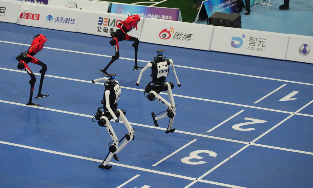 Humanoid robots compete in the 100m final race during the World Humanoid Robot Games in Beijing, Wednesday, Aug. 26, 2026. (AP Photo/Achmad Ibrahim)