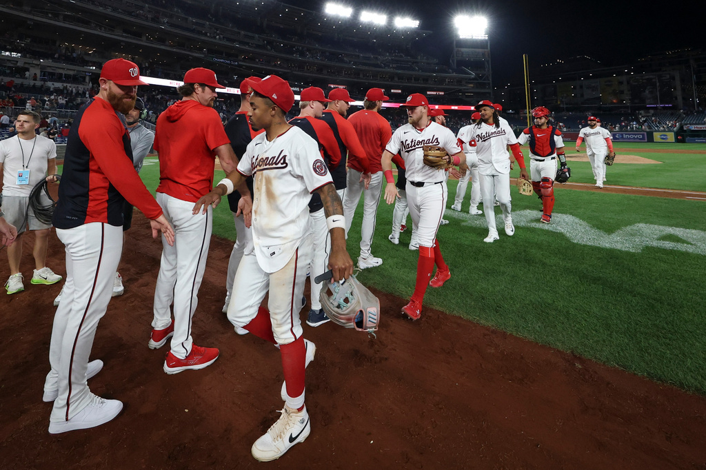 Washington Nationals players greet each other after defeating the Kansas City Royals in a baseball game, Monday, June 15, 2026, in Washington. (AP Photo/Terrance Williams)