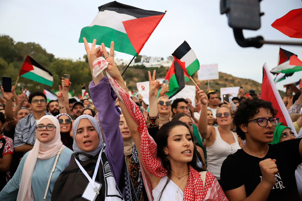 Tunisian people chant in support of the the Global Sumud Flotilla as it arrives at the port of Sidi Bou Saïd, in Tunis, Tunisia, Sunday, Sept. 7, 2025. (AP Photo/Anis Mili)