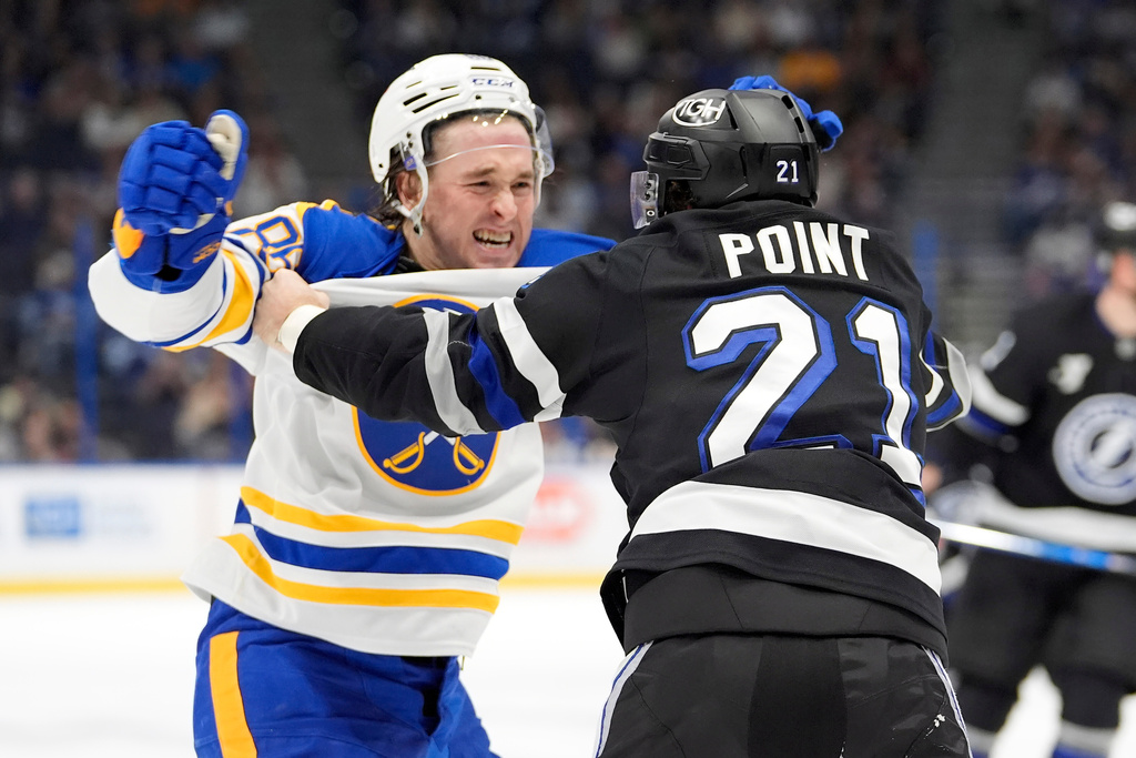 Tampa Bay Lightning center Brayden Point (21) and Buffalo Sabres center Noah Ostlund (86) scrap during the second period of an NHL hockey game Saturday, Feb. 28, 2026, in Tampa, Fla. (AP Photo/Chris O'Meara)