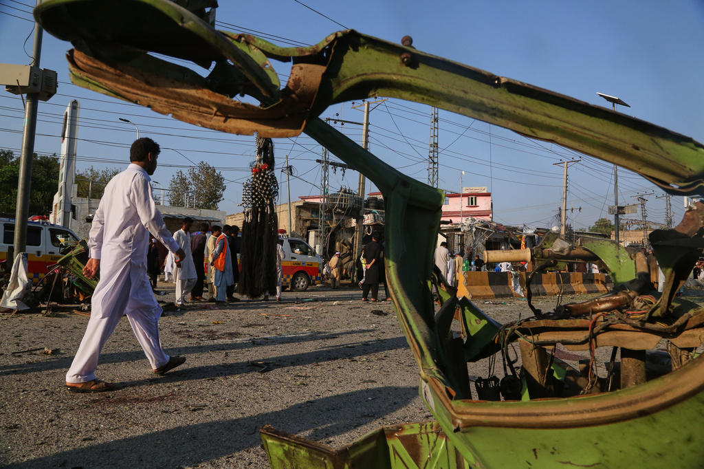 Local residents look at damages at the site following a bomb explosion at a mosque in Kohat, in northwestern Pakistan, Friday, Sept. 18, 2026. (AP Photo/Muhammad Sajjad)