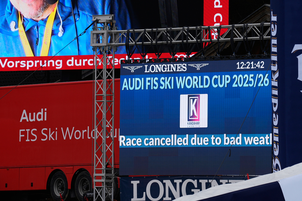 A giant screen reports that a men's World Cup super-G race was cancelled due to bad weather, in Garmisch Partenkirchen , Germany, Sunday, March 1, 2026. (AP Photo/Giovanni Auletta)