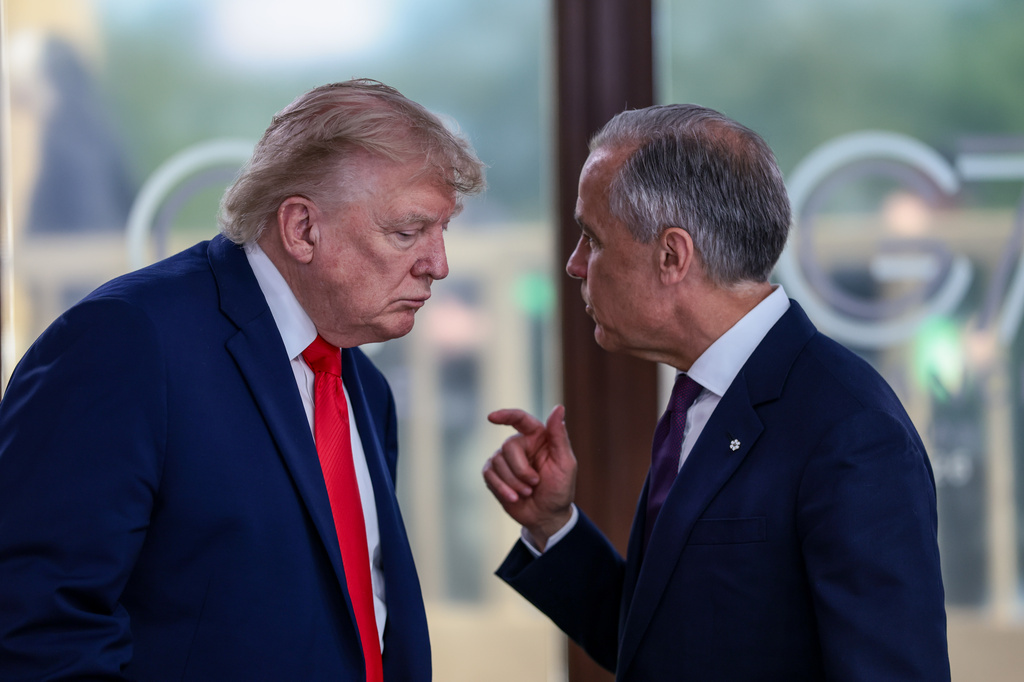 FILE - President Donald Trump speaks with Canadian Prime Minister Mark Carney, right, at a working lunch with leaders of G7 and the Middle East in Evian-les-Bains, France, Tuesday, June 16, 2026. (Evelyn Hockstein/Pool Photo via AP,File)