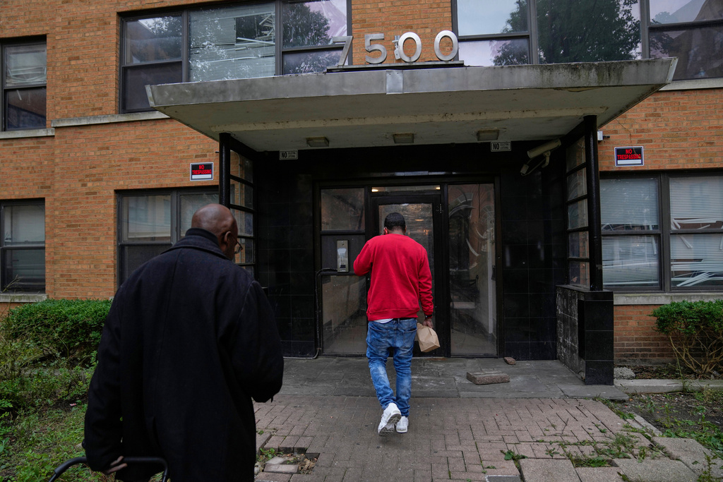 People enter the building on Oct. 10, 2025, at 7500 South Shore Drive in Chicago, which was raided by federal agents on Sept. 30. (AP Photo/Erin Hooley)