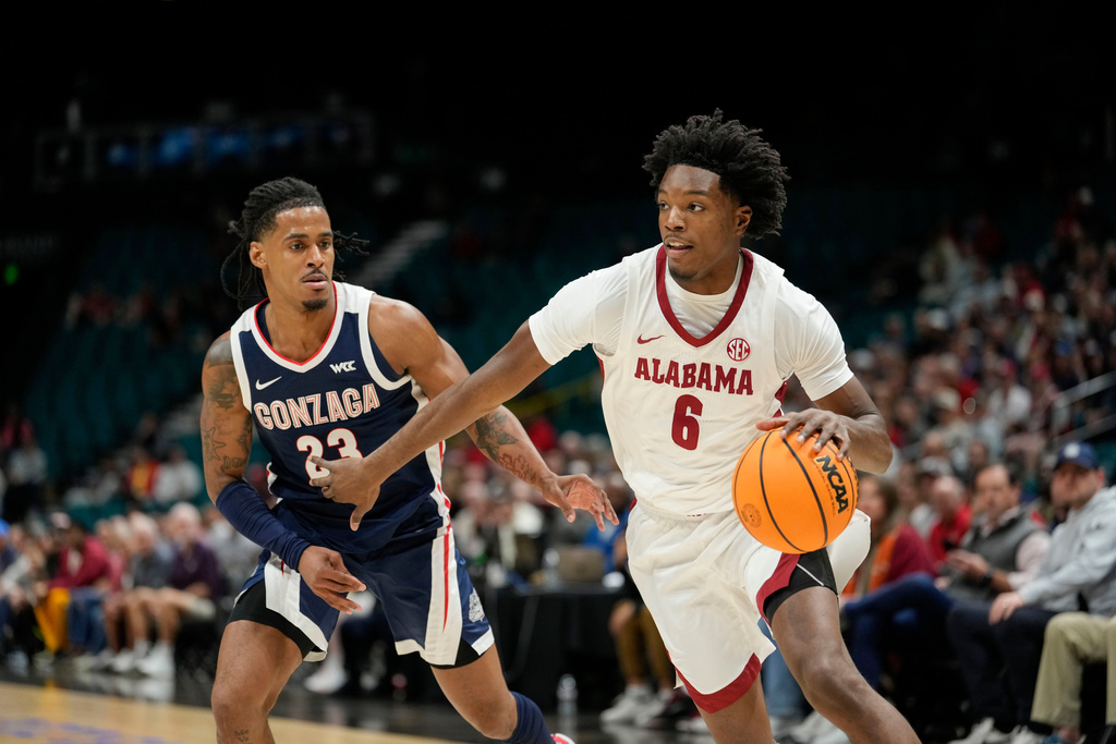 Alabama forward London Jemison (6) drives the ball against Gonzaga guard Adam Miller (23) during the first half of an NCAA college basketball game Monday, Nov. 24, 2025, in Las Vegas. (AP Photo/Lucas Peltier)