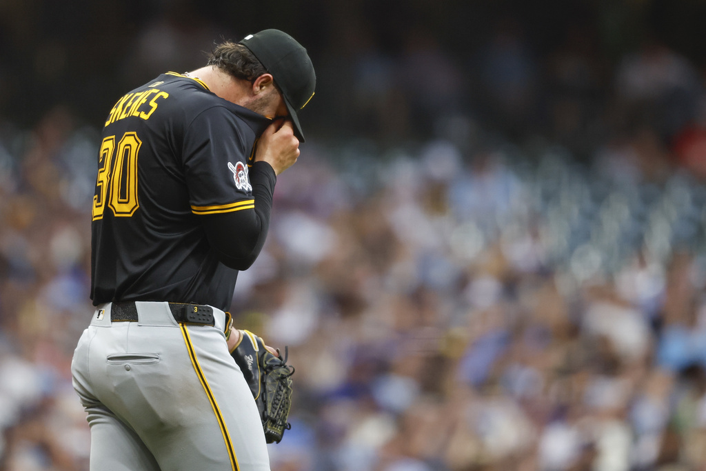 Pittsburgh Pirates starting pitcher Paul Skenes wipes his face during the fourth inning of a baseball game against the Milwaukee Brewers, Tuesday, Aug.12, 2025, in Milwaukee. (AP Photo/Jeffrey Phelps)