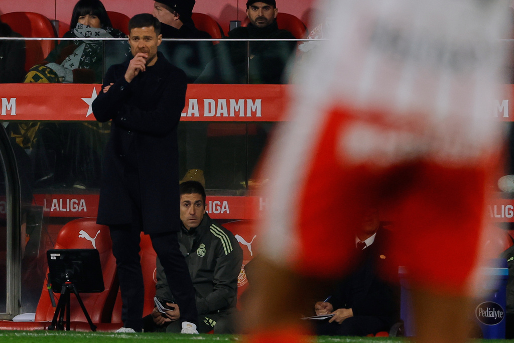 Real Madrid's head coach Xabi Alonso follows the match during a Spanish La Liga soccer match between Girona and Real Madrid, in Girona, Spain, Sunday, Nov. 30, 2025. (AP Photo/Joan Monfort)