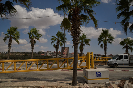 A vehicle with a Palestinian license plate moves past a gate set up by Israeli authorities at the entrance of the West Bank town of Turmus Ayya, Tuesday, Sept. 30, 2025. (AP Photo/Leo Correa) A vehicle with a Palestinian license plate moves past a gate set up by Israeli authorities at the entrance of the West Bank town of Turmus Ayya, Tuesday, Sept. 30, 2025. (AP Photo/Leo Correa)