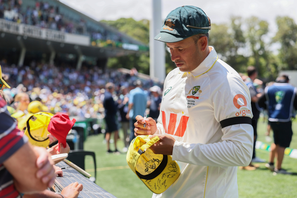 Australia's Usman Khawaja sign autograph to fans after they won the third Ashes cricket test match against England in Adelaide, Australia, Sunday, Dec. 21, 2025 (AP Photo/James Elsby)