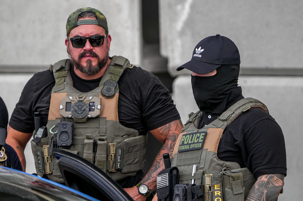 Immigration and Customs Enforcement officers stand at the scene where a man was shot in his vehicle by an ICE officer, Sunday, Sept. 20, 2026, in Austin, Texas. (Aaron E. Martinez /Austin American-Statesman via AP)