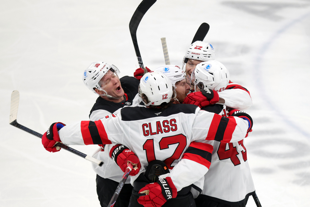 New Jersey Devils forward Ondrej Palat (18), forward Cody Glass (12), forward Connor Brown (16) defenseman Brett Pesce (22) and defenseman Luke Hughes (43) celebrate Hughes' goal against the Columbus Blue Jackets during the third period of an NHL hockey game in Columbus, Ohio, Wednesday, Dec. 31, 2025. (AP Photo/Paul Vernon)