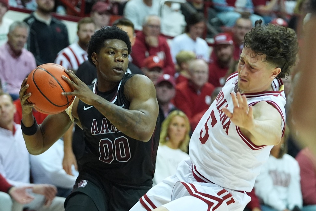 Alabama A&M's Kintavious Dozier (00) is fouled by Indiana's Conor Enright (5) during the first half of an NCAA college basketball game, Wednesday, Nov. 5, 2025, in Bloomington, Ind. (AP Photo/Darron Cummings)