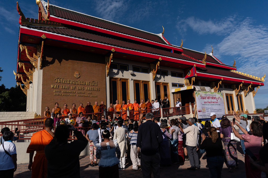 Bhikkhu Pannakara, a Buddhist monk who led a Walk for Peace from Fort Worth, Texas, to Washington, D.C., and fellow monks take group pictures at Wat Thai of Los Angeles in the North Hollywood section of Los Angeles, Monday, July 13, 2026.(AP Photo/Jae C. Hong)