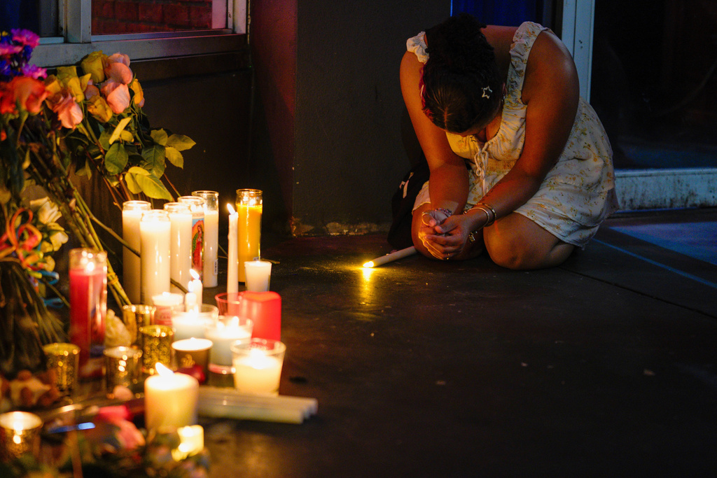 Heavyn Harris prays as she pays her respects during a vigil for the victims of an overnight crash of a vehicle involved in a high speed chase, which caused several deaths and multiple injuries at Bradley's on 7th, a popular LGBTQ+ nightclub, Saturday, Nov. 8, 2025, in Tampa, Fla. (Martha Asencio-Rhine/Tampa Bay Times via AP)