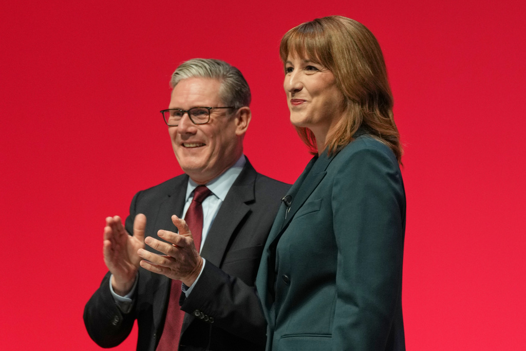 Britain's Chancellor of the Exchequer Rachel Reeves, left, stands next to the Prime Minister Keir Starmer, who applauds after she gave her keynote speech during the annual Labour Party conference in Liverpool, England, Monday, Sept. 29, 2025. (AP Photo/Jon Super)