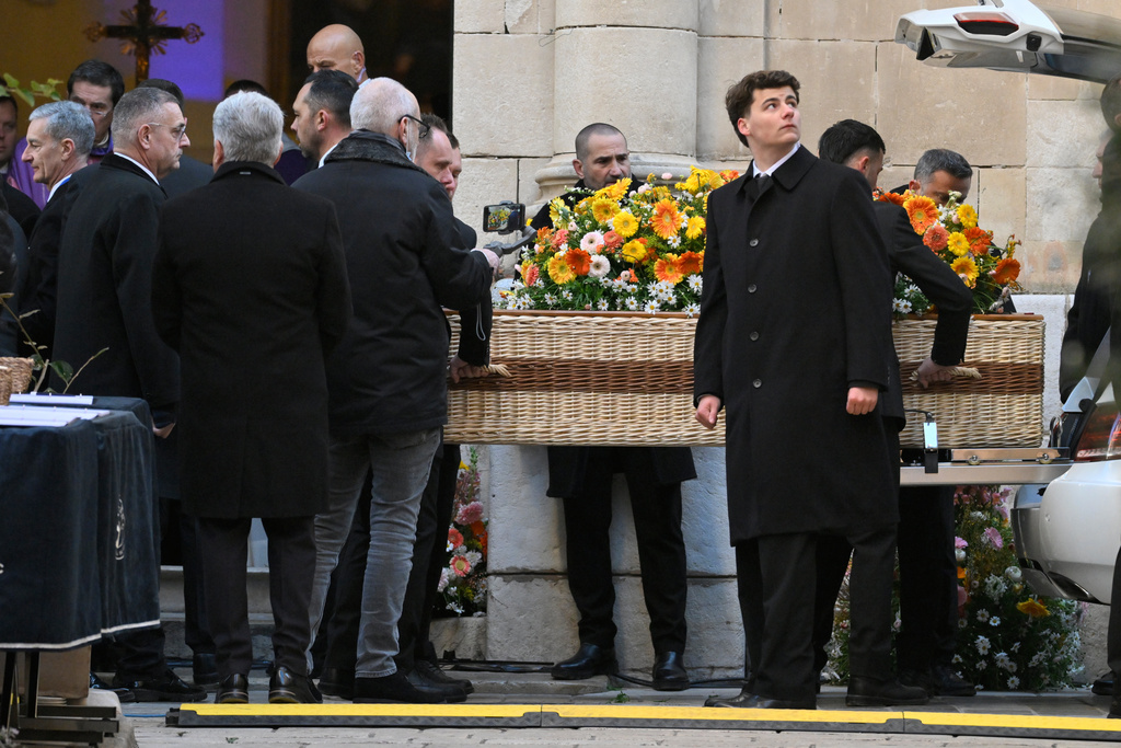 Actor Brigitte Bardot's coffin is carried outside Notre-Dame de l'Assomption church for her funeral ceremony, Wednesday, Jan. 7, 2026 in Saint-Tropez, southern France. (AP Photo/Philippe Magoni)