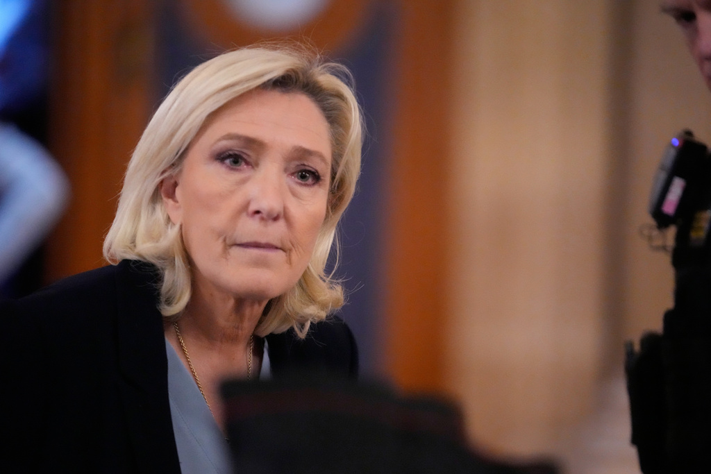 Far-right leader Marine Le Pen, left, walks outside the courtroom during a short break in her appeals trial in Paris, Tuesday, Jan. 20, 2026. (AP Photo/Michel Euler)