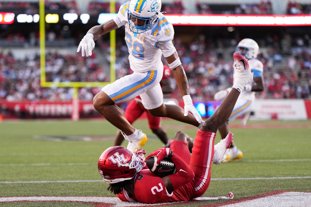 Houston wide receiver Koby Young (2) catches a pass for a touchdown against Southern cornerback Cayden Jones (28) during the first half of an NCAA college football game in Houston, Saturday, Sept. 12, 2026. (AP Photo/Ashley Landis)
