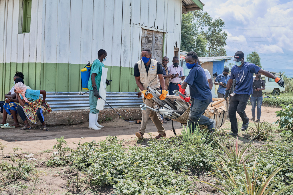 Aid workers carry supplies to set up an Ebola treatment center in Bunia, Congo, Tuesday, May 19, 2026. (AP Photo/Dirole Lotsima Dieudonne)