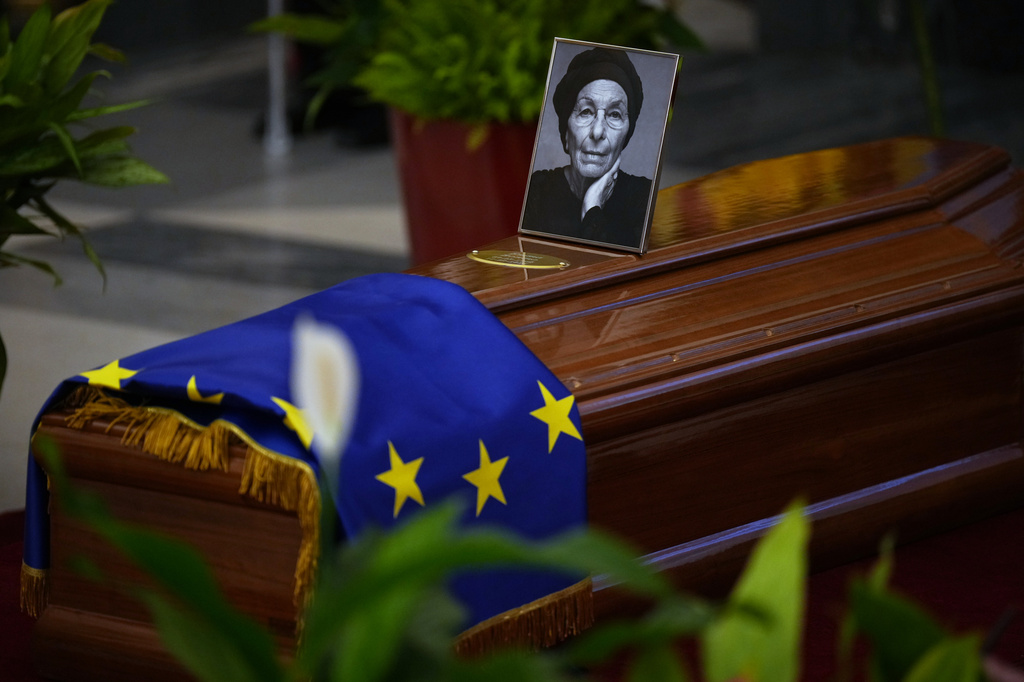 A European Union flag and a photo of Emma Bonino, who rose to political prominence in the 1970s campaigning to legalize abortion in heavily Roman Catholic Italy, are placed on a coffin during her lying in state in Rome's City Hall, Sunday, Sept. 13, 2026. (AP Photo/Andrew Medichini)