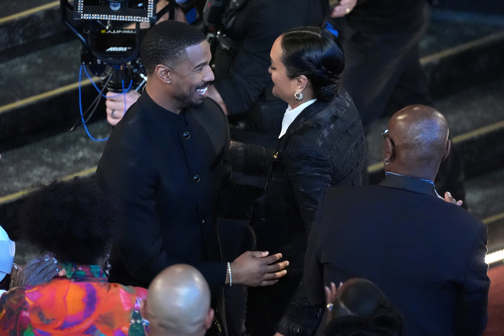 Michael B. Jordan, left, congratulates Autumn Durald Arkapaw for winning the award for best cinematography for "Sinners" during the Oscars on Sunday, March 15, 2026, at the Dolby Theatre in Los Angeles. (AP Photo/Chris Pizzello)