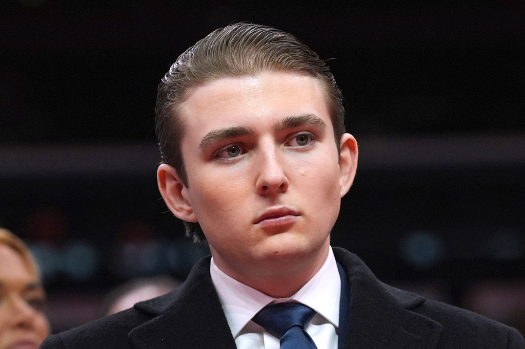 FILE - Barron Trump watches as his father, President Donald Trump attends an indoor Presidential Inauguration parade event at Capital One Arena, in Washington, Jan. 20, 2025. (AP Photo/Evan Vucci, File)