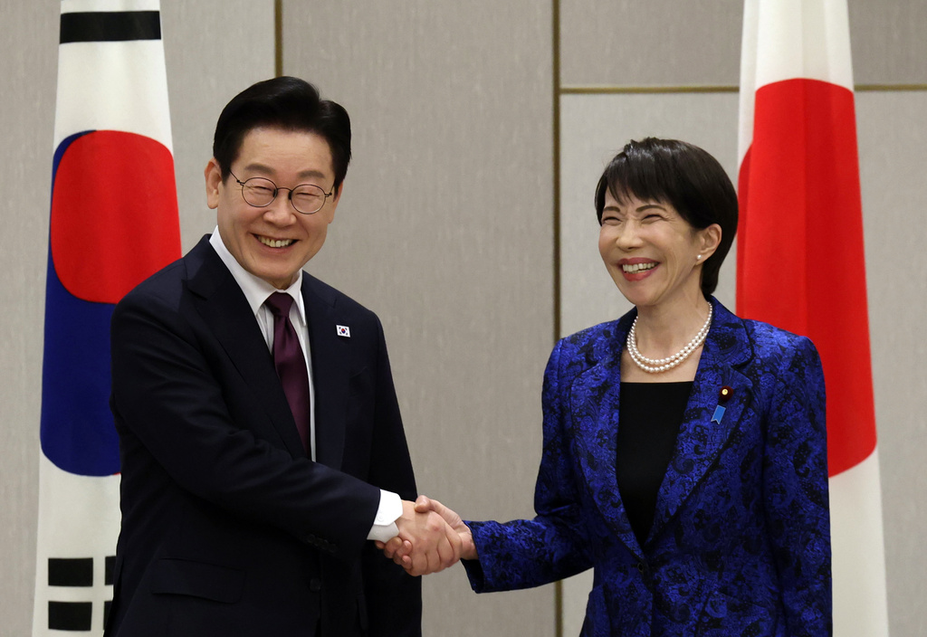 Japan's Prime Minister Sanae Takaichi, right, shakes hands with South Kore's President Lee Jae Myung at the start of their meeting in Nara, western Japan Tuesday, Jan. 13, 2026. (Issei Kato/Pool Photo via AP)