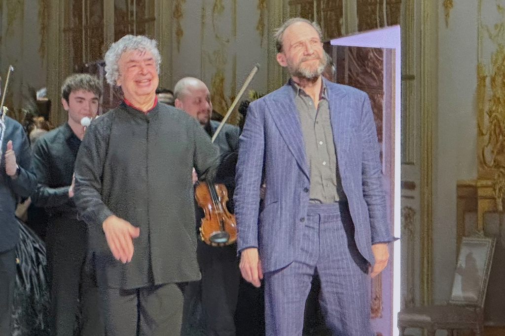 Ralph Fiennes, right, appears with conductor Semyon Bychkov during curtain calls after his opera directing debut of Tchaikovky’s “Eugene Onegin” at the Palais Garnier in Paris on Monday, Jan. 26, 2026. (AP Photo/Ron Blum)