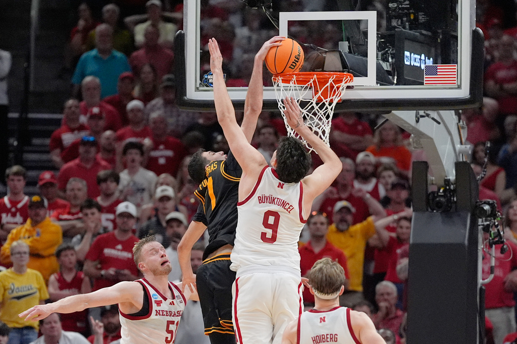 Iowa forward Alvaro Folgueiras (7) dunks over Nebraska forward Berke Buyuktuncel (9) during the second half in the Sweet 16 of the NCAA college basketball tournament Thursday, March 26, 2026, in Houston. (AP Photo/Ashley Landis)